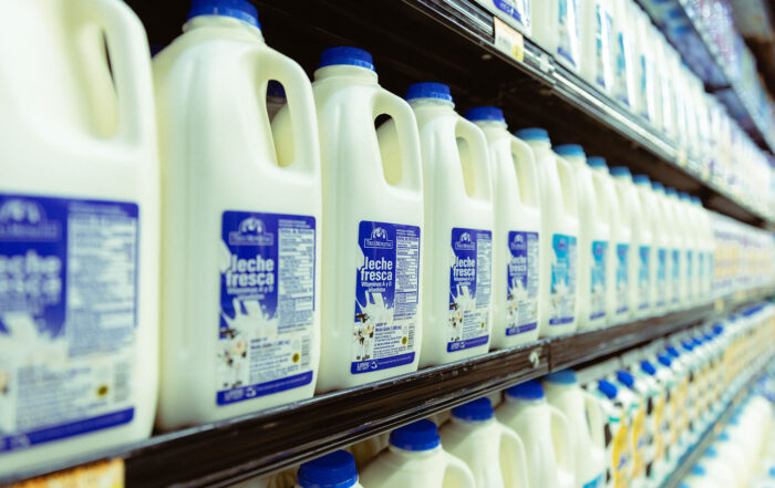 Leche fresca Tres Monjitas en varias presentaciones en la nevera de un supermercado